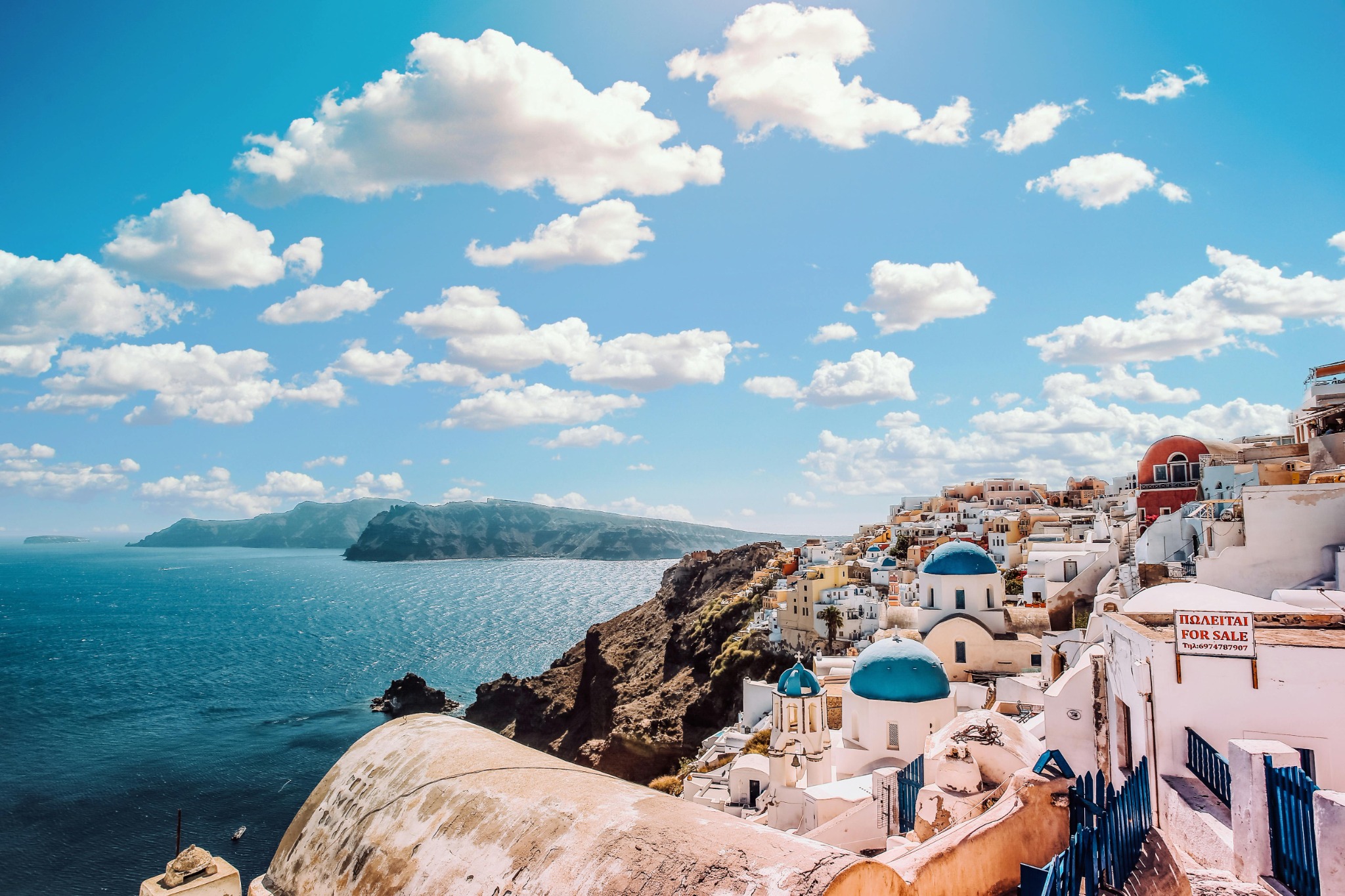 Santorini landscape with white buildings and blue domes